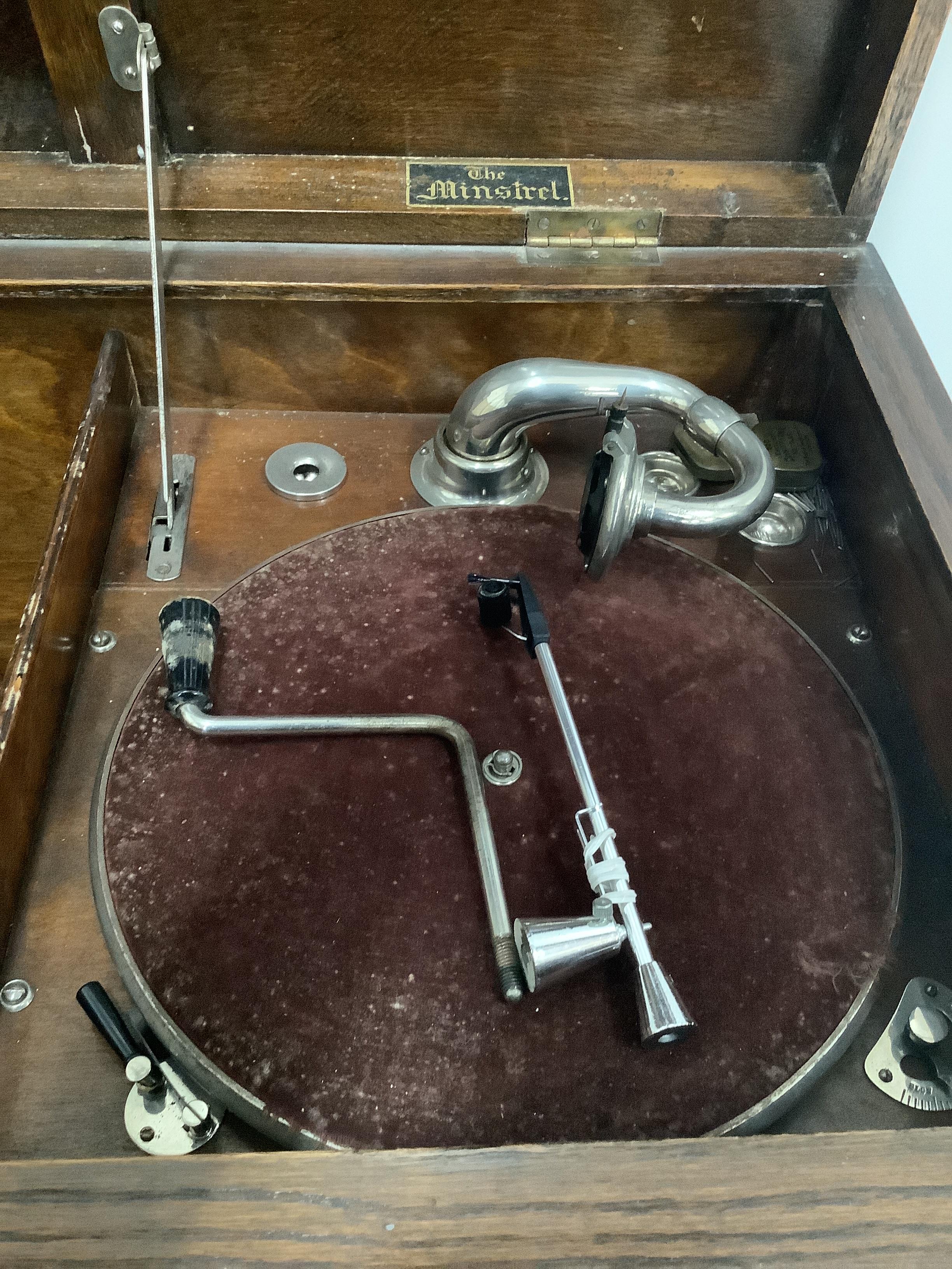 An early 20th century oak cased wind-up gramophone 'The Minstrel', width 74cm, depth 46cm, height 82cm, together with a small quantity of 78 rpm records
